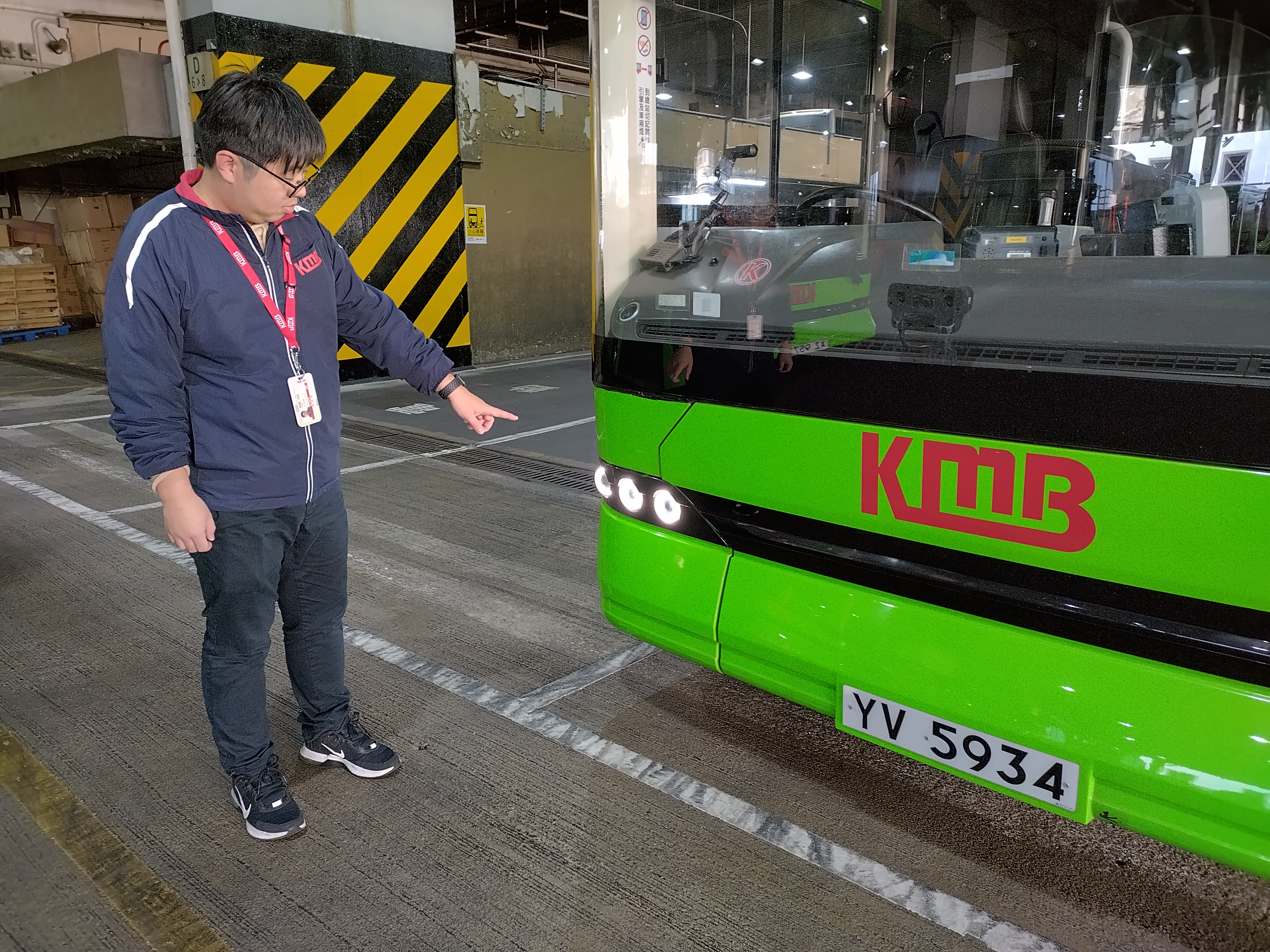 Bus captain checks headlights before driving